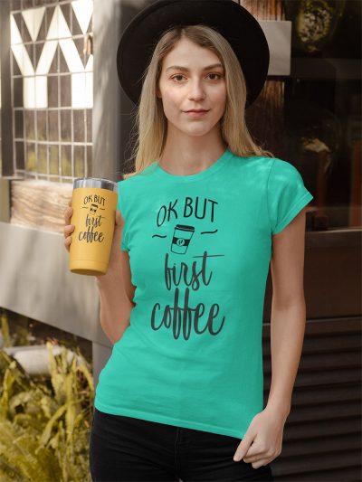 woman wearing ok but first coffee t-shirt and holding a big coffee cup