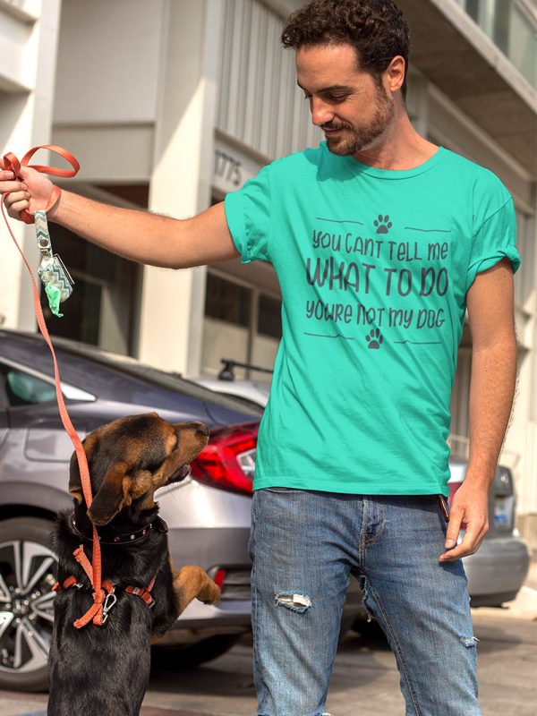 Man wearing dog lovers t-shirt and playing with his dog