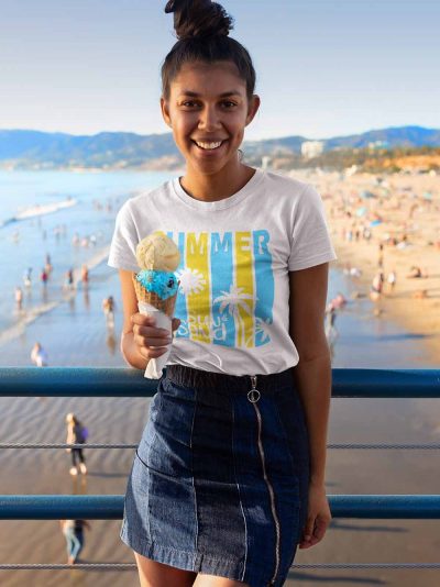 Girl wearing Summer Beach T-shirt standing at the beach.